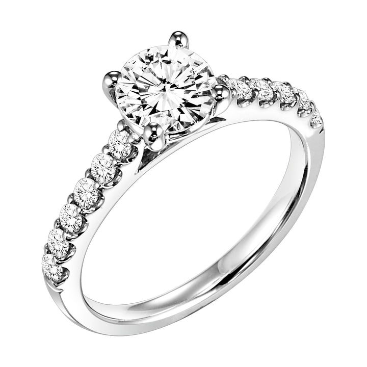 Round prong set diamonds grace the band of this engagement ring featuring a brilliant round diamond center stone for a timeless yet class look.  Center Stone is not included.