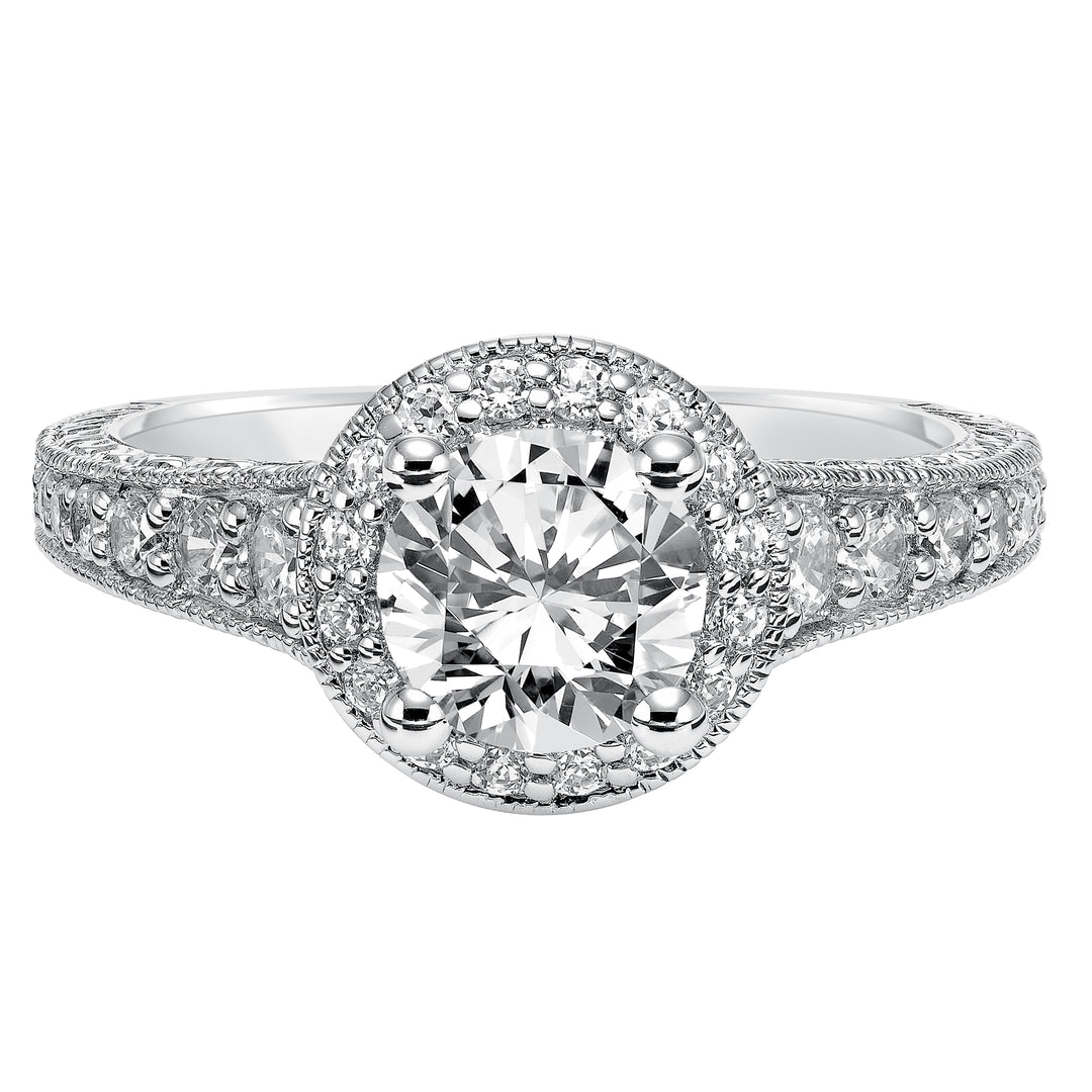 This show-stopping engagement ring is sure to impress with its diamond prong set halo and band with milgrain and engraving