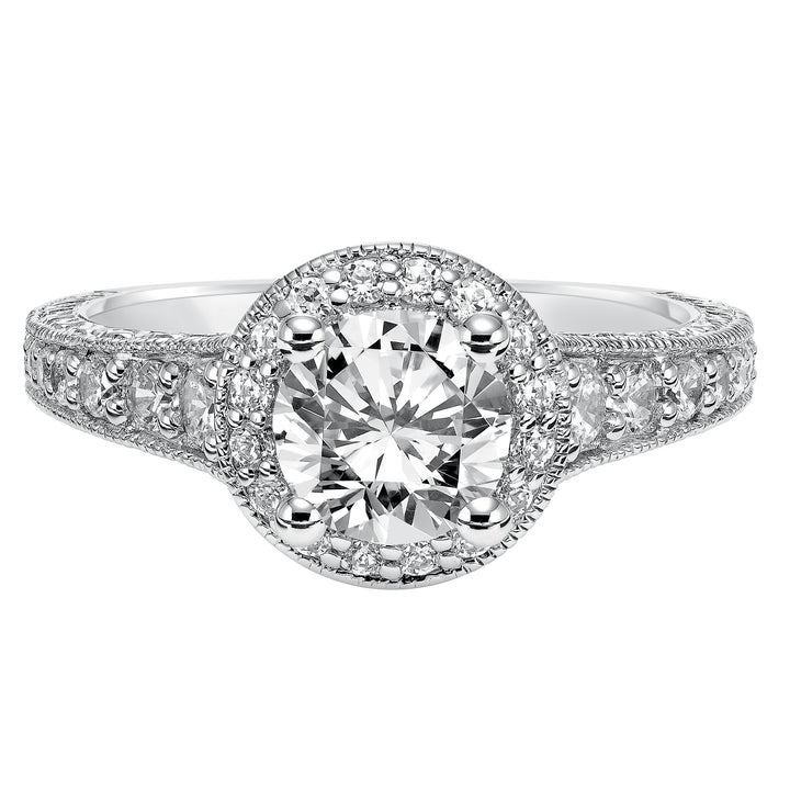 This show-stopping engagement ring is sure to impress with its diamond prong set halo and band with milgrain and engraving