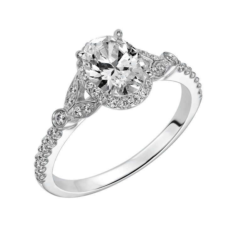 This romantic and beautiful engagement ring features an oval cut diamond accentuated by a prong set diamond halo and petal-inspired band design.  Center Stone is not included.