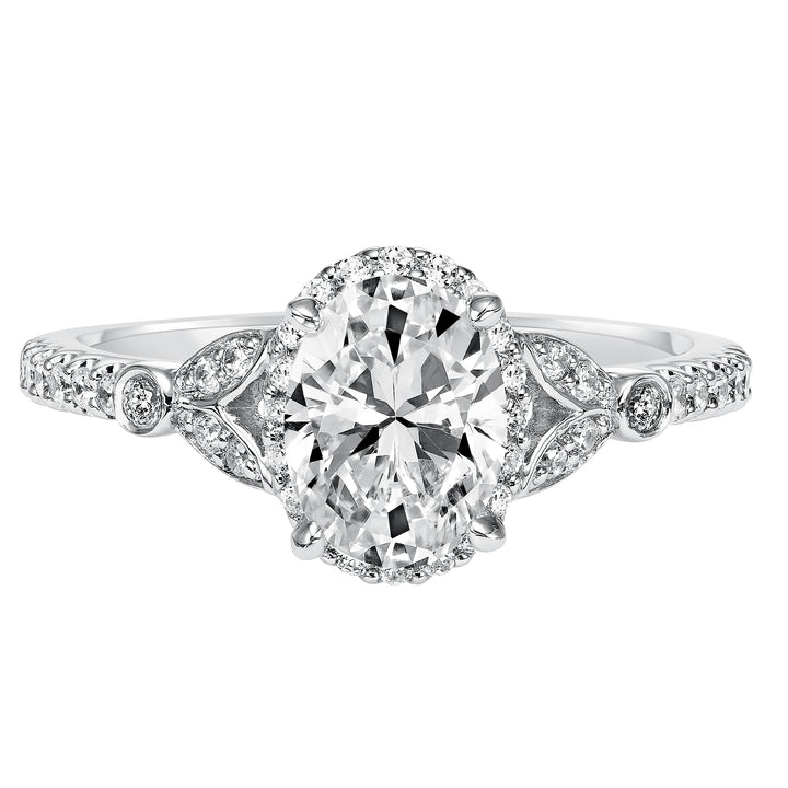 This romantic and beautiful engagement ring features an oval cut diamond accentuated by a prong set diamond halo and petal-inspired band design