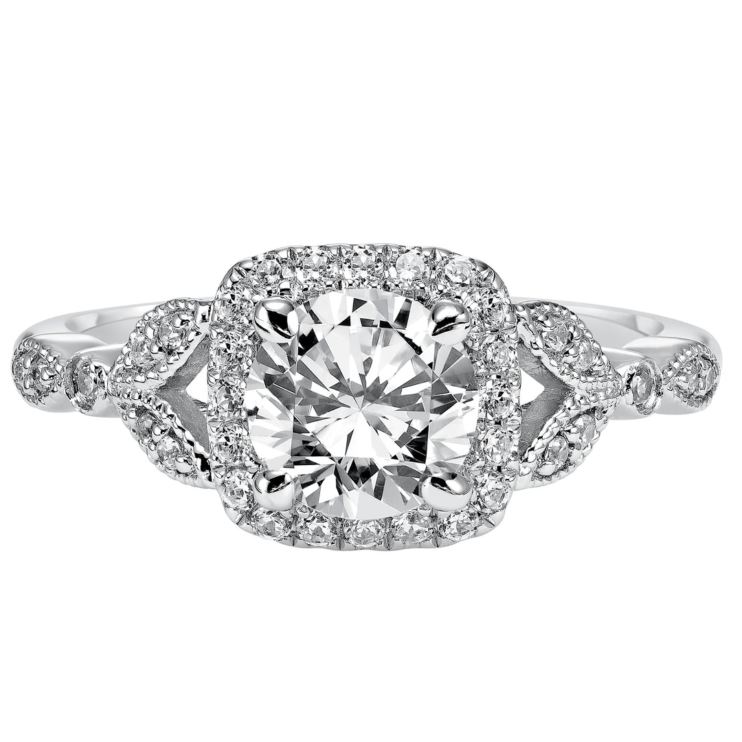 This whimsically styled engagement ring sparkles with its filigree and diamond halo and diamond prong set floral-inspired band