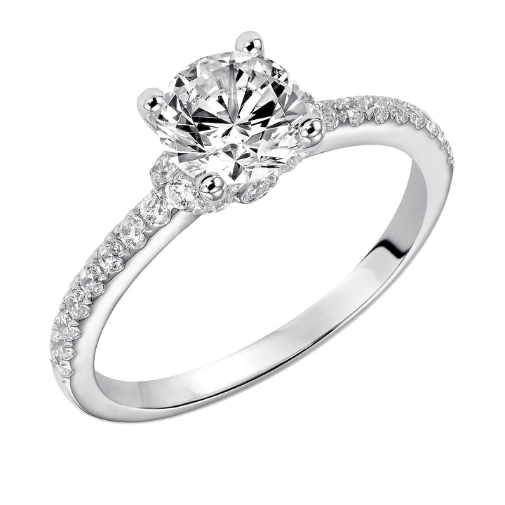 This engagement ring celebrates classic elegance with its delicate diamond prong set band and diamond tiara accent