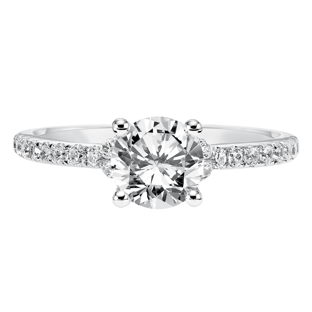 This engagement ring celebrates classic elegance with its delicate diamond prong set band and diamond tiara accent
